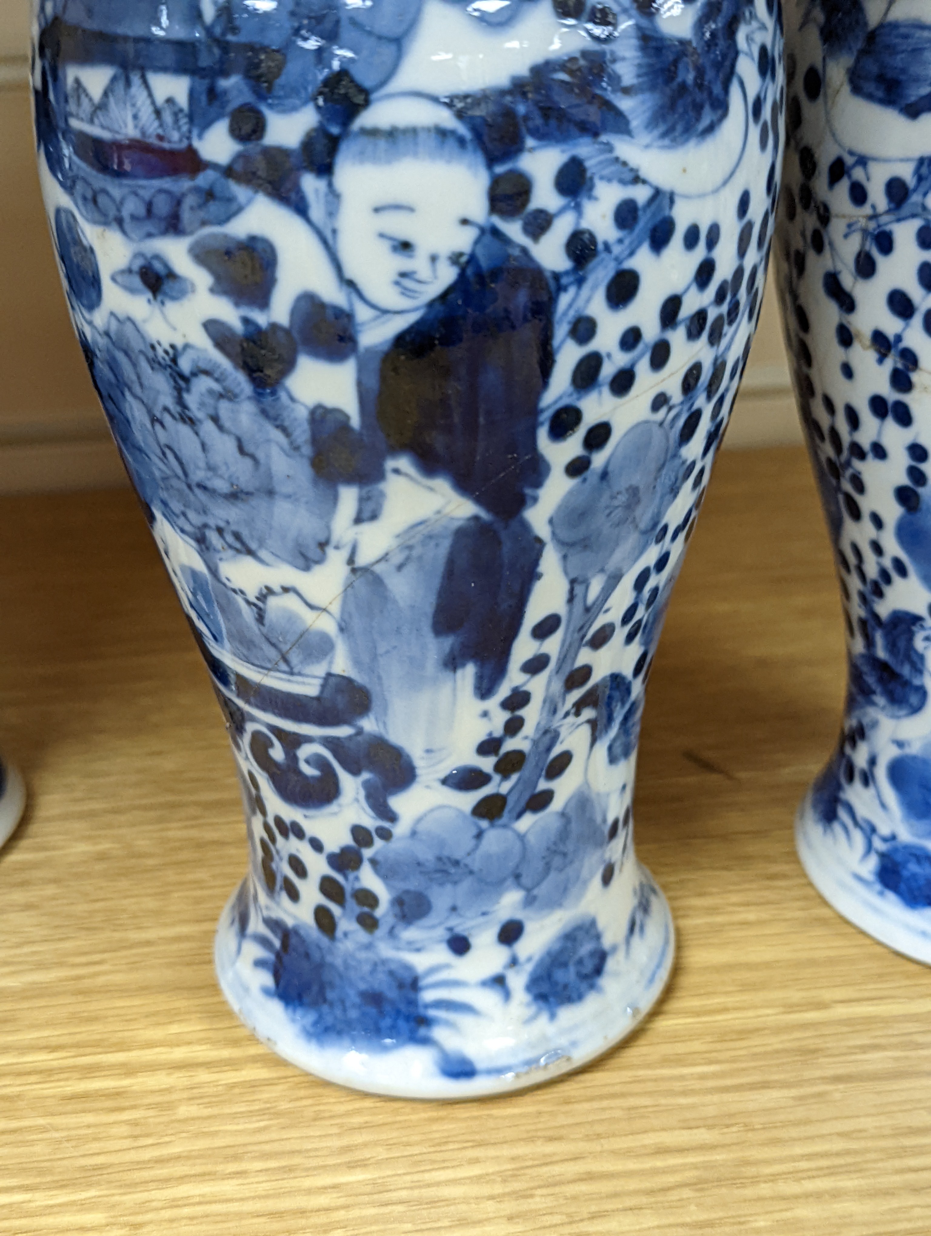 A pair of 19th century Chinese blue and white vases, a prunus vase and cover and a similar jar (4), pair of vases 24 cms high.